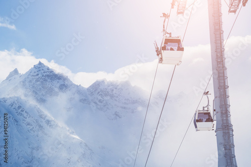 Cable car on the ski resort and snow-covered mountains