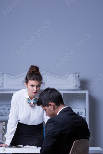 Powerful woman reprimanding male employee