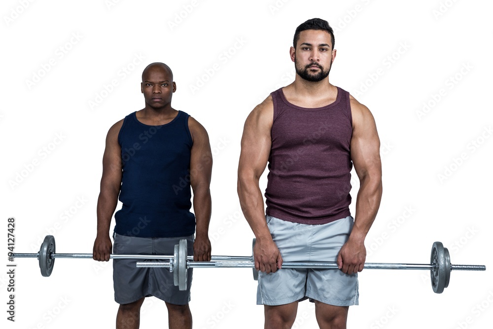 Man lifting barbell with trainer Man lifting barbell with trainer