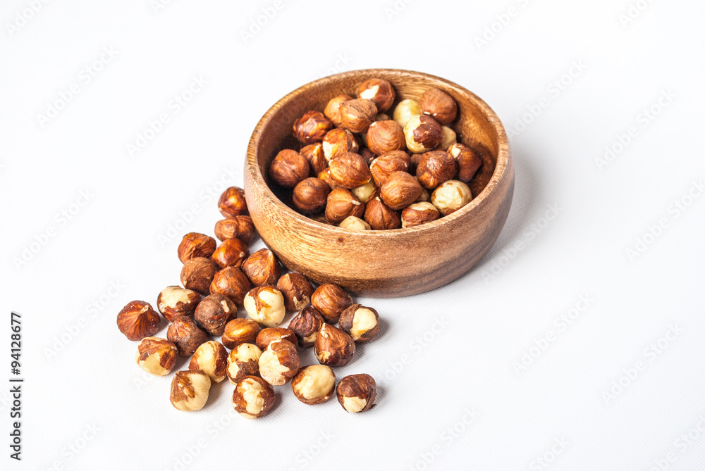 Hazelnuts in a Wooden Bowl on White Background Hazelnuts in a Wooden Bowl on White Background