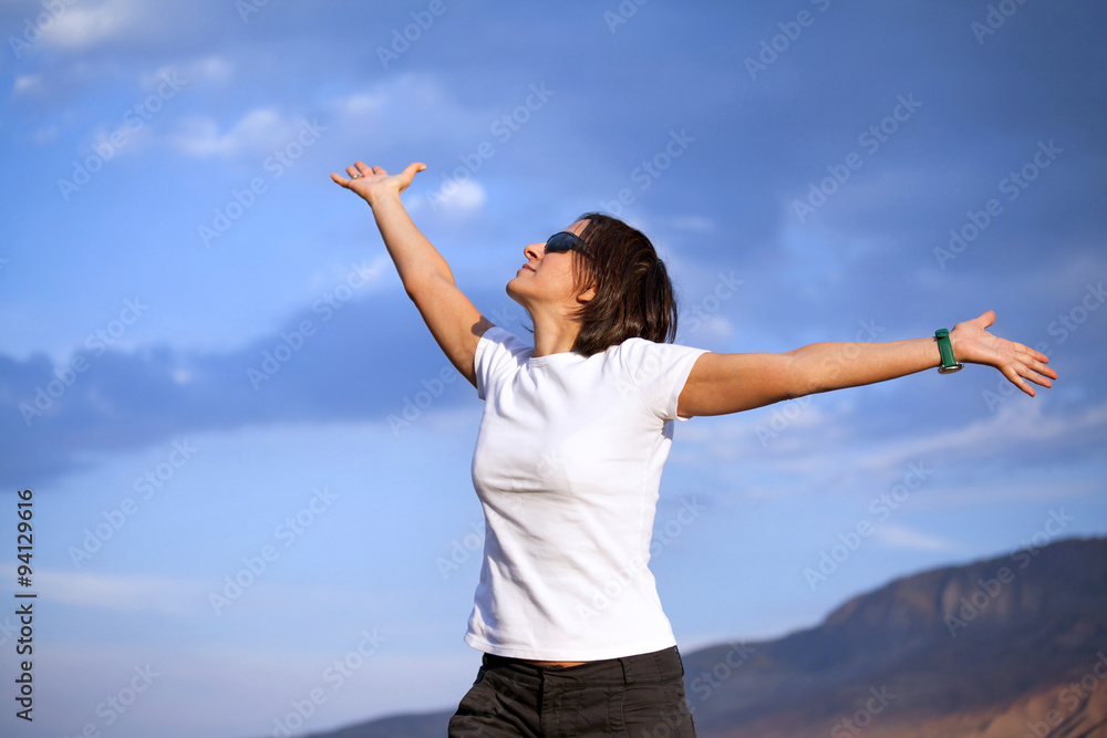 Healthy and happy young woman greets the mountains Healthy and happy young woman greets the mountains