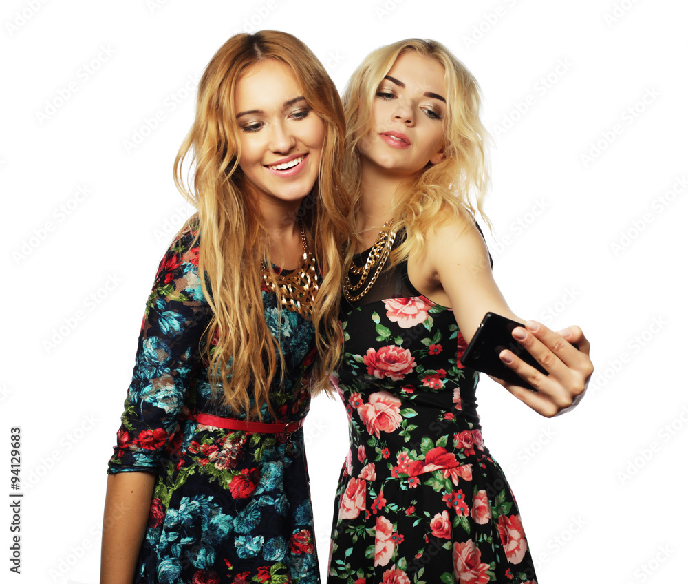 two young women taking selfie with mobile phone two young women taking selfie with mobile phone