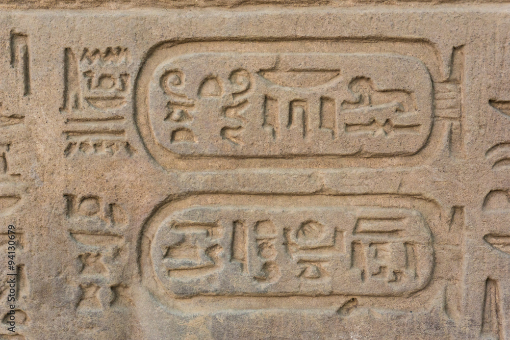 Egyptian hieroglyphics on the stone wall 