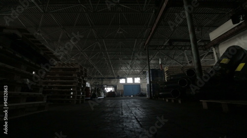 Two men go on camera with a tool, leaving the warehouse.