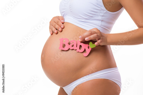 Wallpaper Mural Pregnant belly with pink inscription for baby girl. Pregnant woman waiting a daughter. Close-up horizontal isolated on white background. Torontodigital.ca