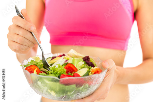 Fitness woman with a bowl of salad