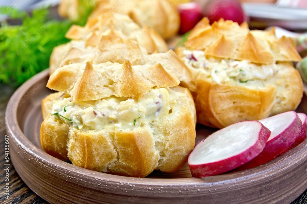 Appetizer of radish and cheese in profiteroles on plate with dil Appetizer of radish and cheese in profiteroles on plate with dil