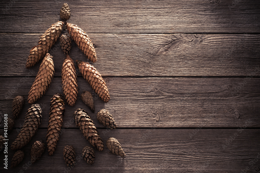 cones in the form of a Christmas tree on a wooden background cones in the form of a Christmas tree on a wooden background