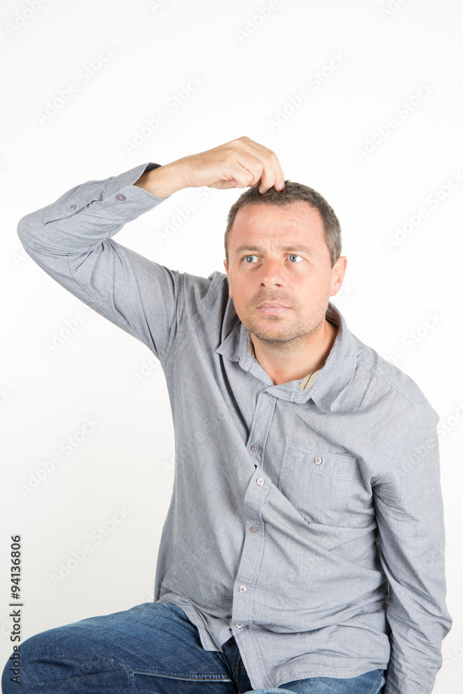 Man looking in a mirror and fixing his hair Man looking in a mirror and fixing his hair