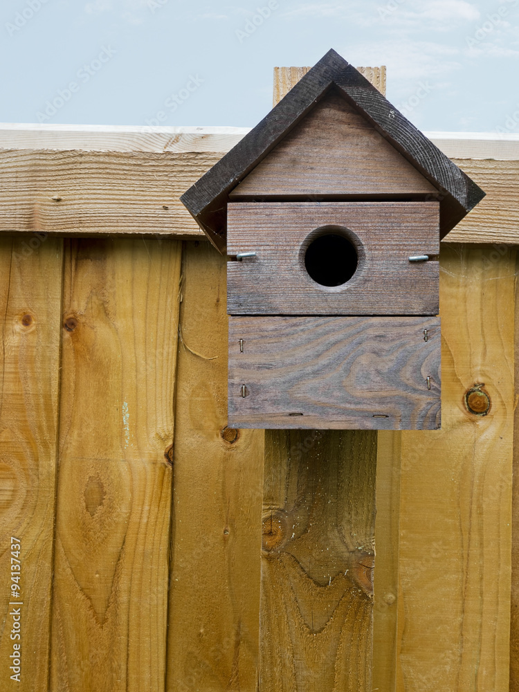 Rustic bird nestbox, nesting box on garden fence