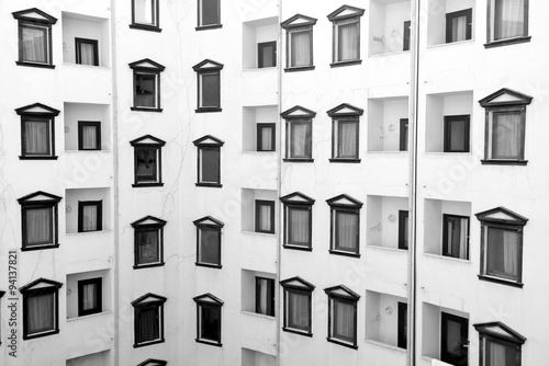 detail facade of black white building with windows and balcony