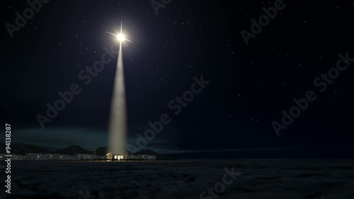 A slow zoom towards a depiction of the nativity scene of christs birth in bethlehem with the isolated run down stable being lit by a bright star photo