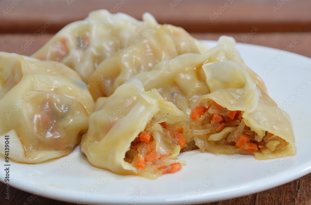 vegetarian Chinese dumpling dressing soy sauce on dish vegetarian Chinese dumpling dressing soy sauce on dish