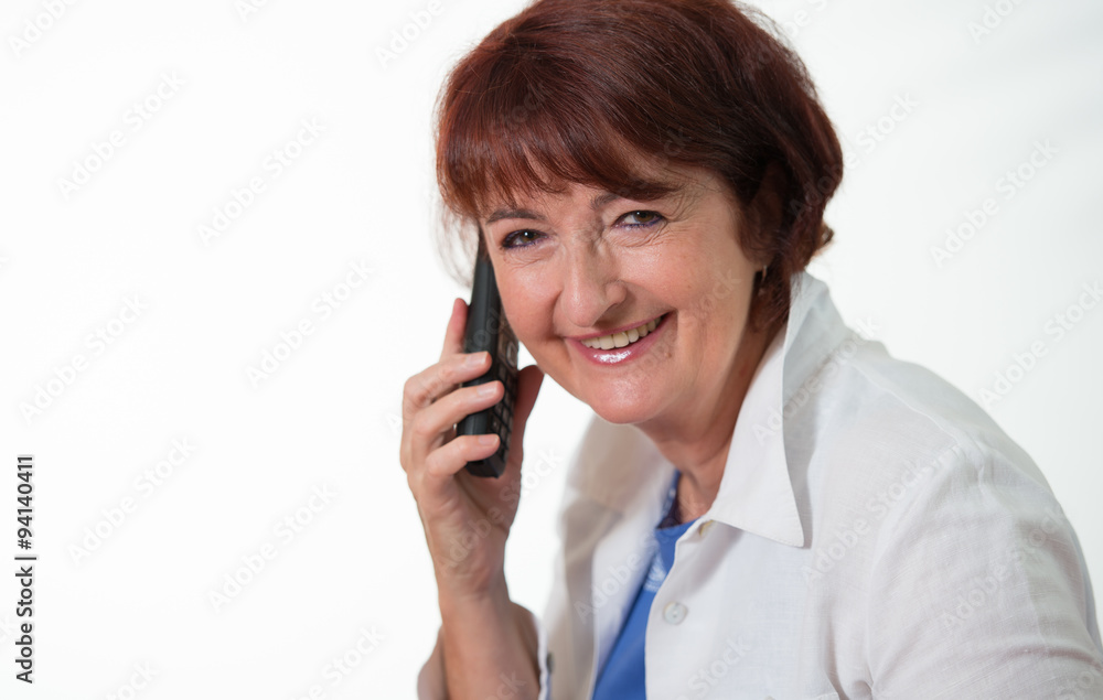 elegant senior woman chatting on her mobile phone smiling with d elegant senior woman chatting on her mobile phone smiling with d