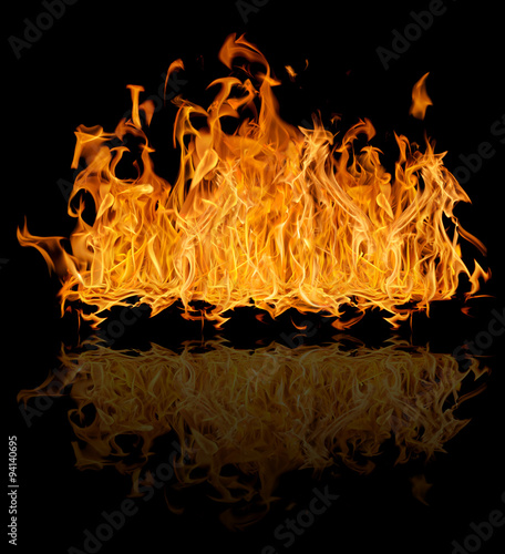 yellow bright large fire with reflection isolated on black