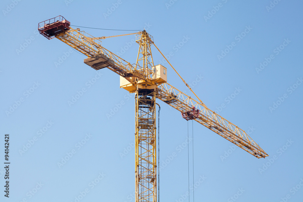 Construction crane against blue sky Construction crane against blue sky
