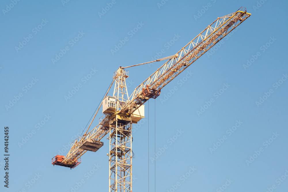 Construction crane against blue sky Construction crane against blue sky