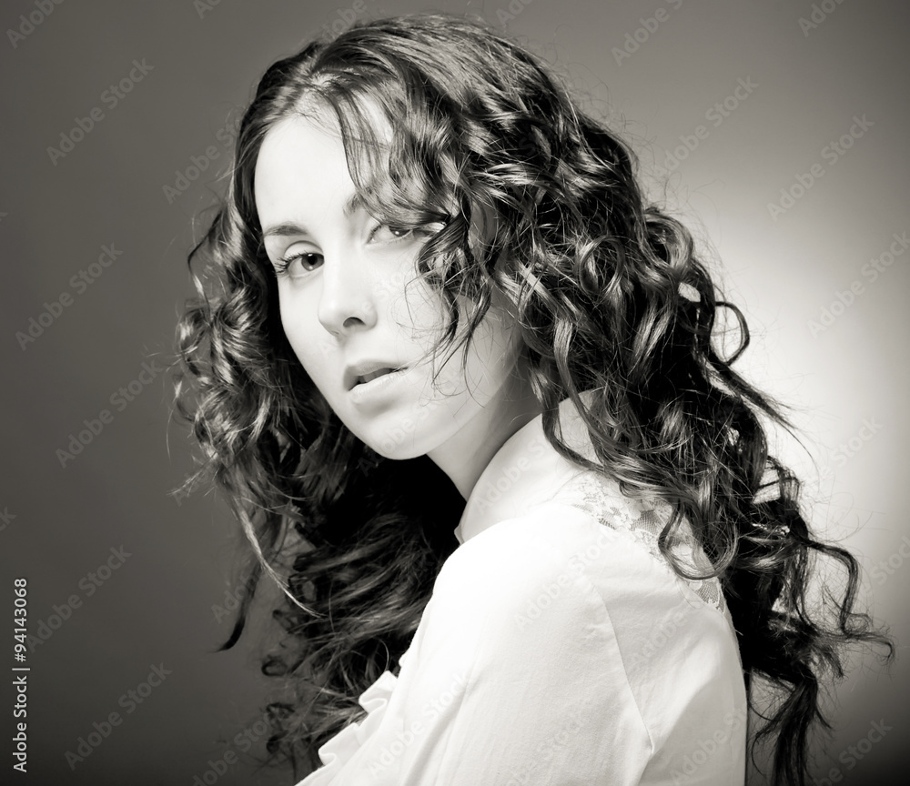 Portrait of pretty young woman with curly hair. Portrait of pretty young woman with curly hair.