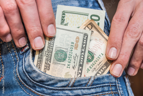 Male hand with dollars in the pocket