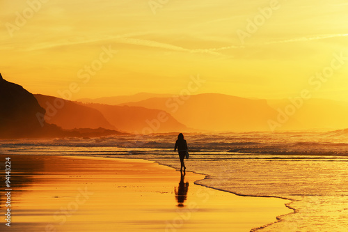 woman walking on beach © mimadeo