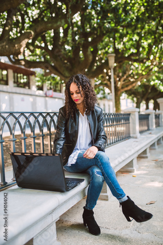 Portrait of a Latin American Afro Woman using her laptop