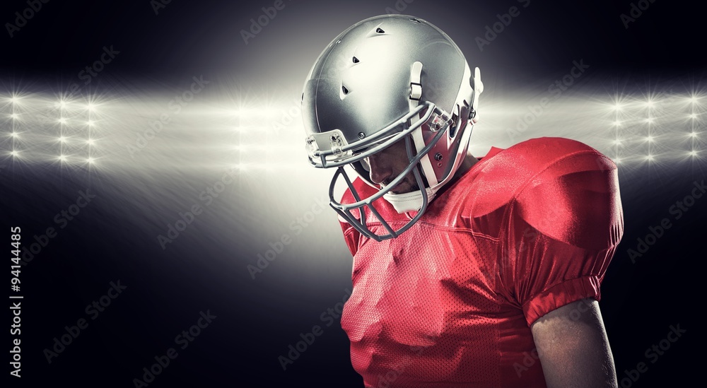 Composite image of american football player looking down Composite image of american football player looking down