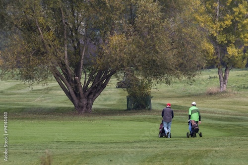 People move around the golf course