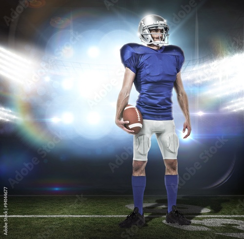 Standing american football player holding ball © vectorfusionart