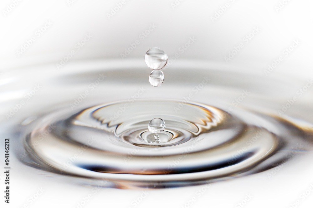 Beautiful image of a drop of water falling into a reservoir creating a ripple Beautiful image of a drop of water falling into a reservoir creating a ripple
