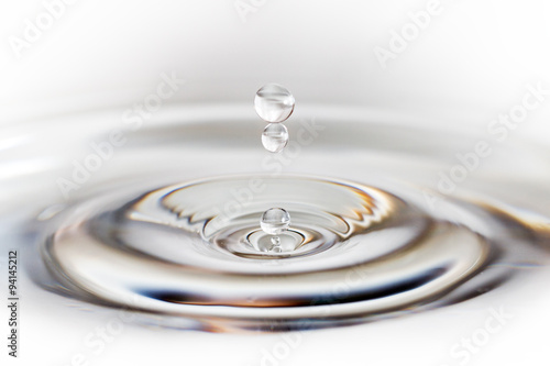 Beautiful image of a drop of water falling into a reservoir creating a ripple