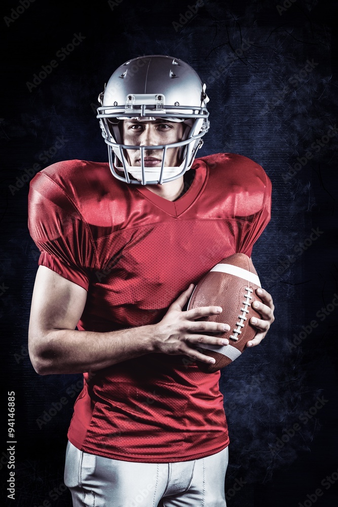 Composite image of american football player holding ball Composite image of american football player holding ball