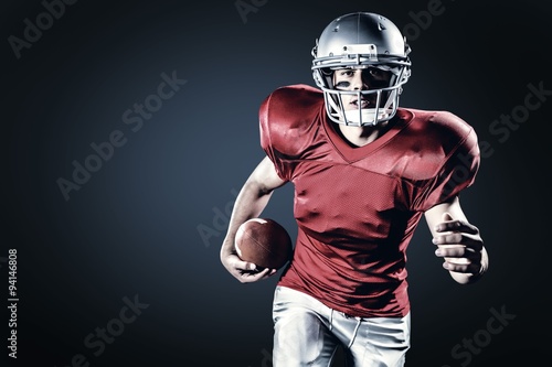 Portrait of sportsman running while holding ball © vectorfusionart