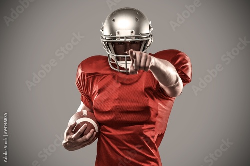 Composite image of portrait sports player in red jersey pointing