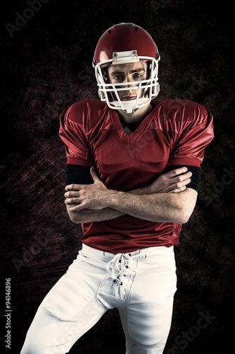 Portrait of serious american football player with arms crossed