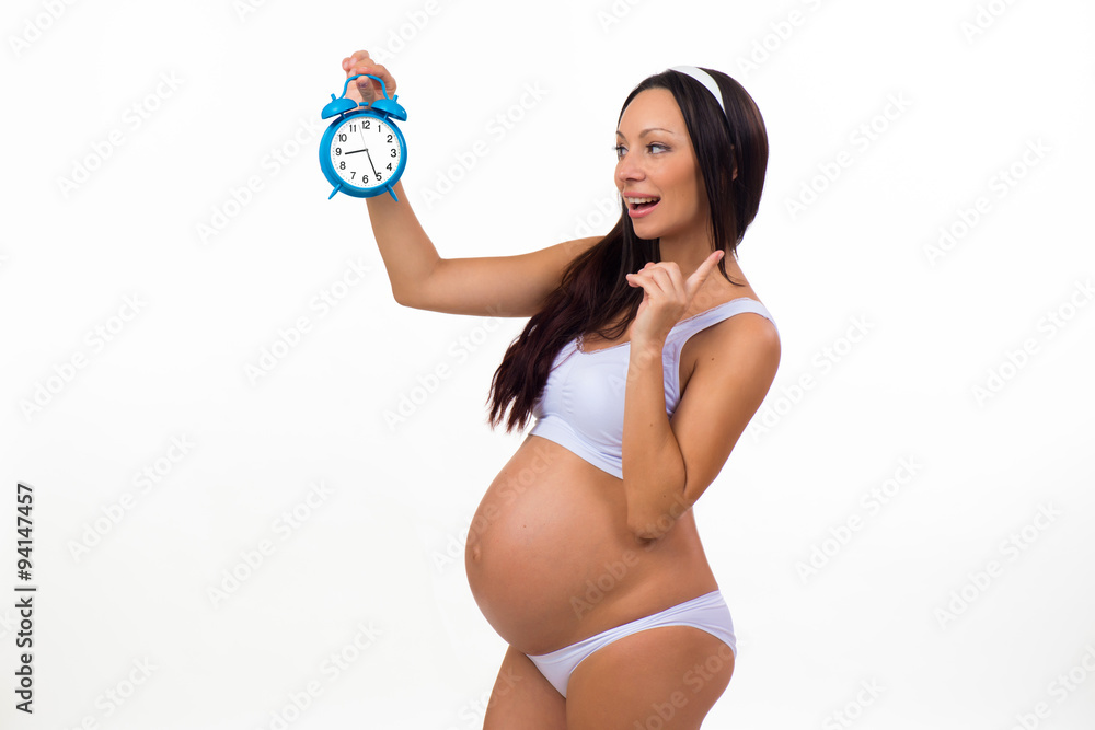 Emotion photo pregnant woman with alarm clock. Surprise. Pregnancy. Soon birth. Emotion photo pregnant woman with alarm clock. Surprise. Pregnancy. Soon birth.