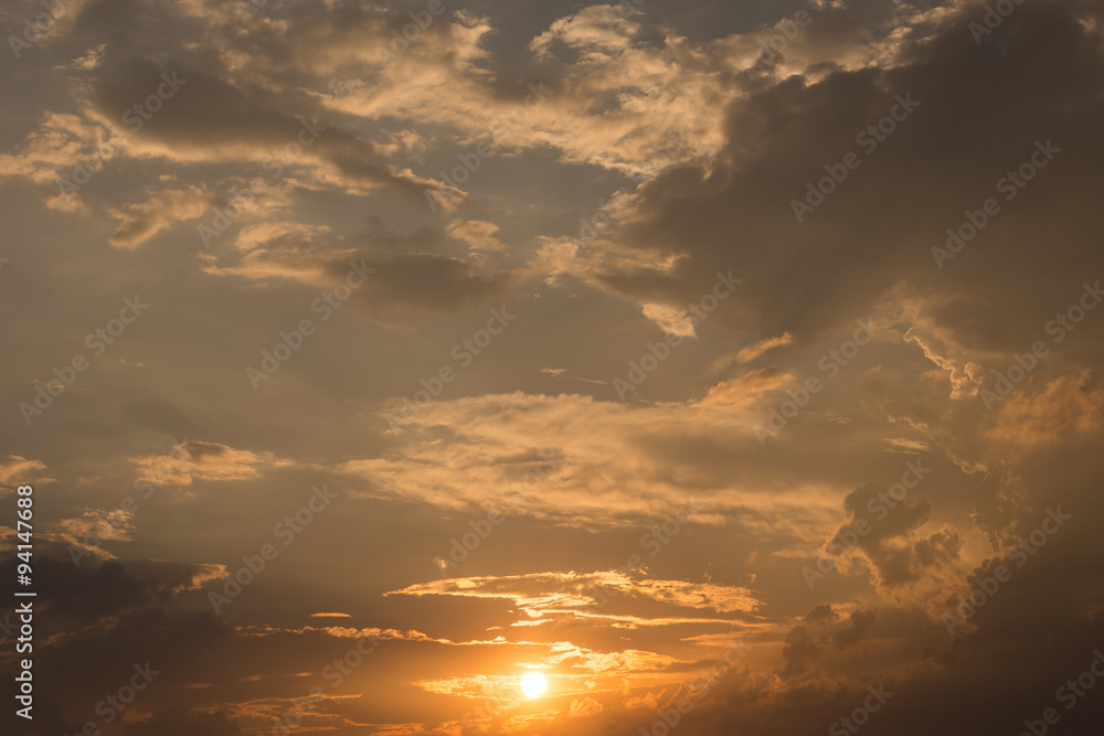 orange sky sunset with sun and black clouds