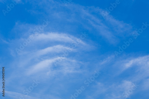 wind blows clouds in blue sky background