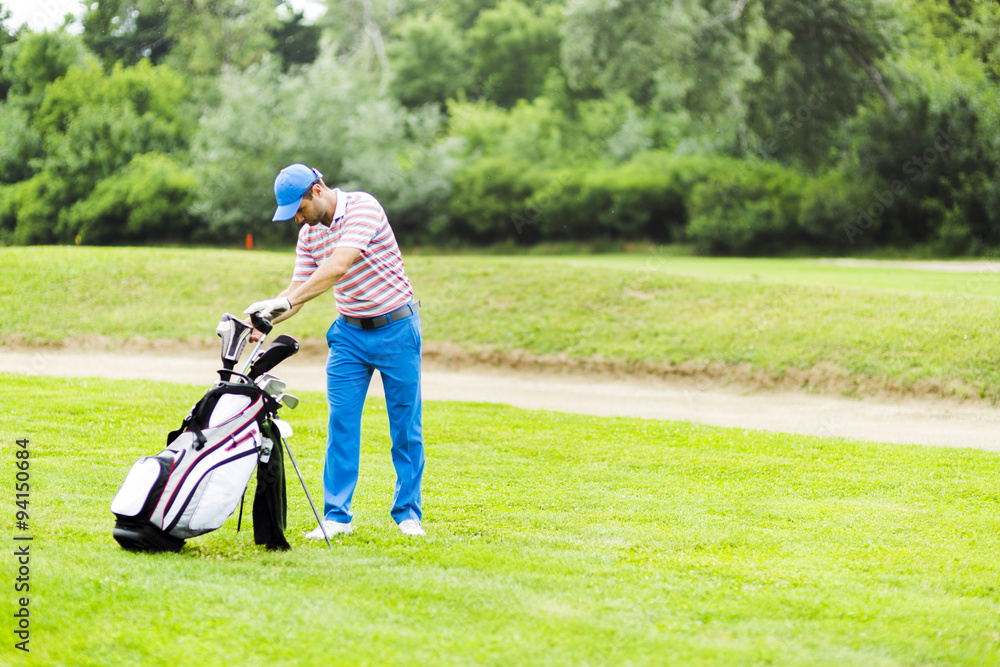 Golfer selecting appropriate club Golfer selecting appropriate club