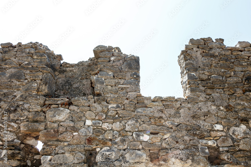 Abandoned ancient ruined wall