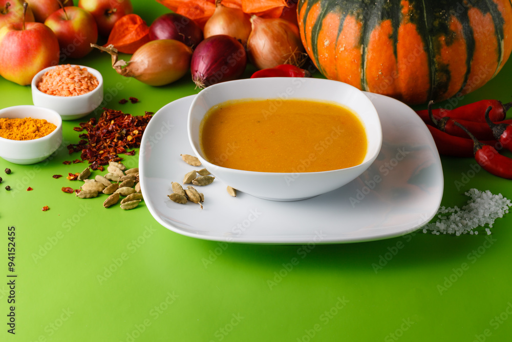 Pumpkin soup with onion and pepper on green shadowless backgroud Pumpkin soup with onion and pepper on green shadowless backgroud