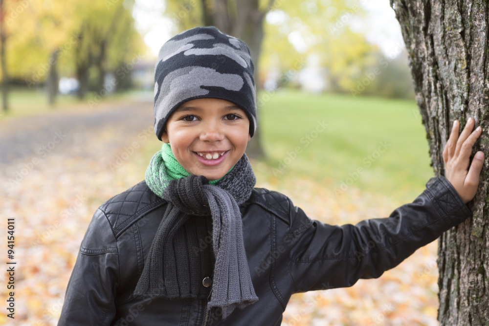 cute boy with autumn leaves in the park cute boy with autumn leaves in the park