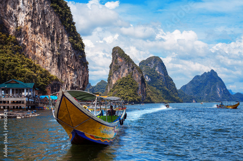 long boat and rocks on railay beach in Thailand © Ulia Koltyrina