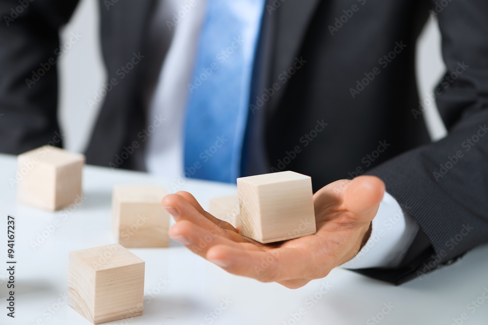 Businessman making tower Businessman making tower