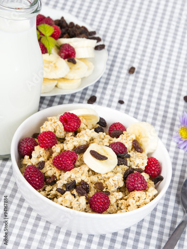 granola with fruits and bottle of fresh milk
