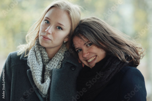 Autumn portrait of two girlfriends girls outside
