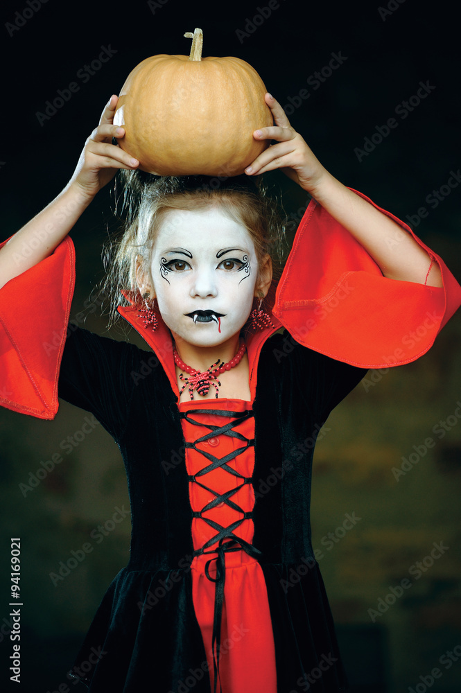 a little girl dressed as a vampire Gothic Halloween/ little girl in the  image of the vampire; preparation for Halloween; costume vampire; vampire  costume for a children's holiday; Stock Photo | Adobe