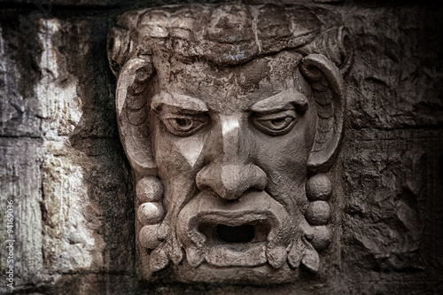 фотографія Stone bas-relief a kind of a head of a demon