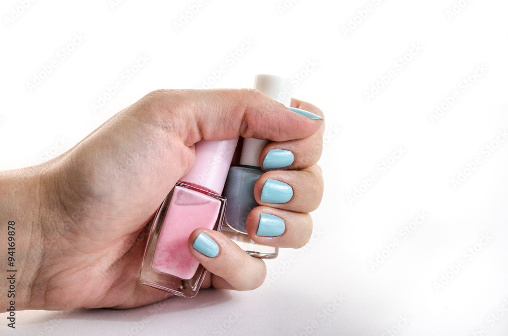 Nail polish in hand, close view, separated on white background