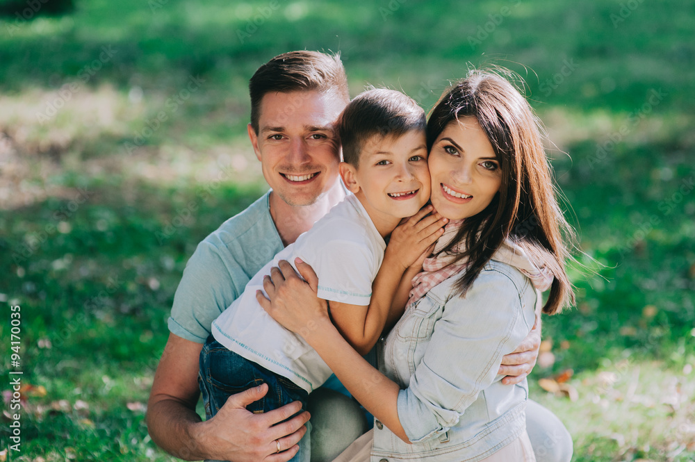 Adorable young family having weekend in a city park Adorable young family having weekend in a city park