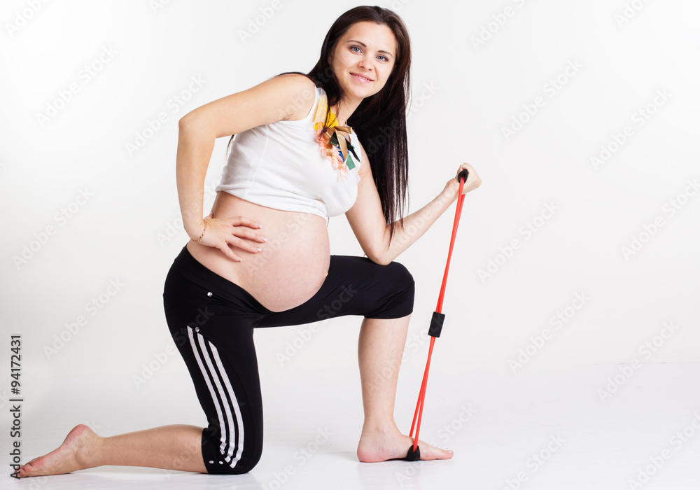 Pregnant woman doing exercises with resistance band Pregnant woman doing exercises with resistance band
